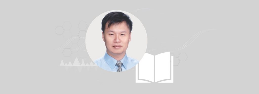 Headshot of Dr Lee Chien-Chang in front of a white open book against a grey background.