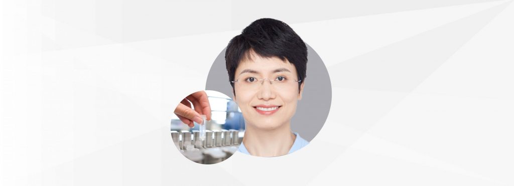 Headshot of Dr Gan Liangyin and a hand holding a sample against a grey backdrop.
