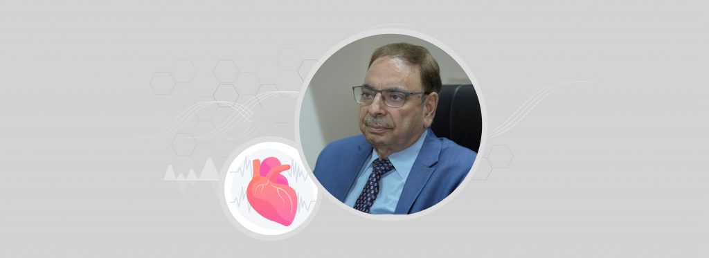 Headshot of Prof. Upendra Kaul with an illustration of a human heart against a grey backdrop.
