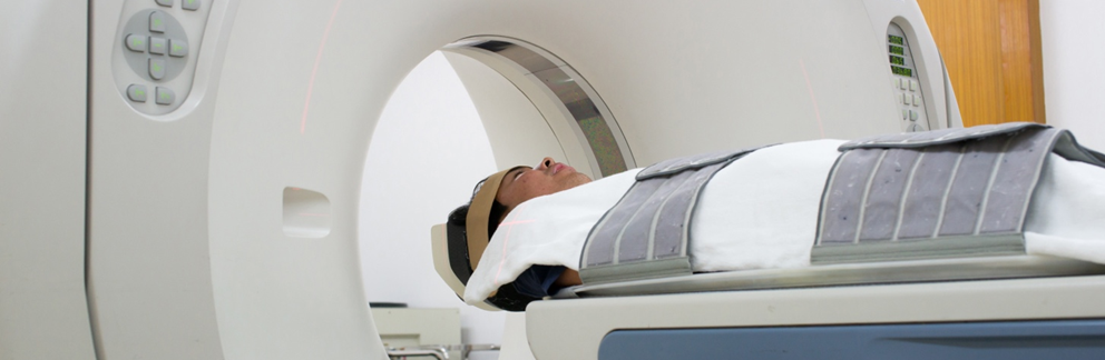Patient lying down to undergo an MRI examination.